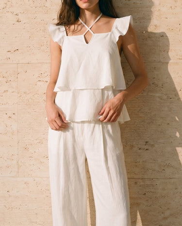 The Seraphine Cotton Set in white — two-piece set with tiered ruffle top, three-quarter front view on model