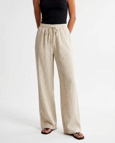 The Seville Stripe Drawstring Pant in brown stripe — wide-leg drawstring trousers, front view on model