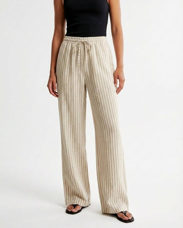 The Seville Stripe Drawstring Pant in brown stripe — striped drawstring trousers, front styling view on model