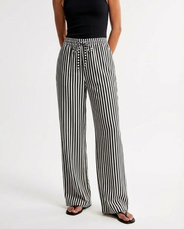 The Seville Stripe Drawstring Pant in black stripe — wide-leg drawstring trousers, front view on model