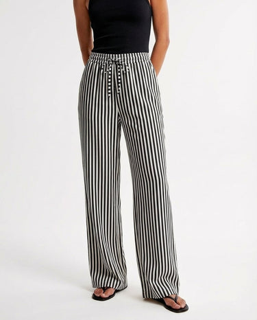 The Seville Stripe Drawstring Pant in black stripe — striped wide-leg trousers, front view on model