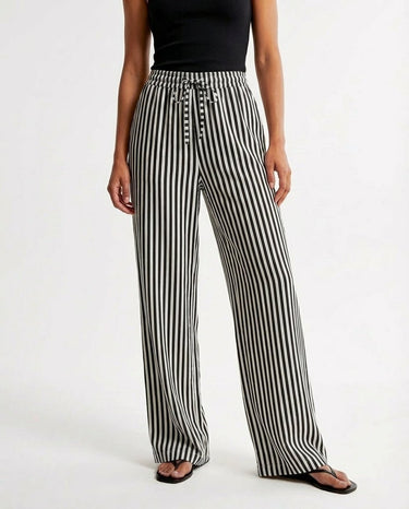 The Seville Stripe Drawstring Pant in black stripe — striped drawstring trousers, front view on model