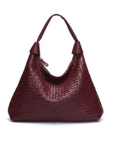 The Siren Woven Bag in burgundy, front view on a pure white studio background showing the woven body and knotted strap