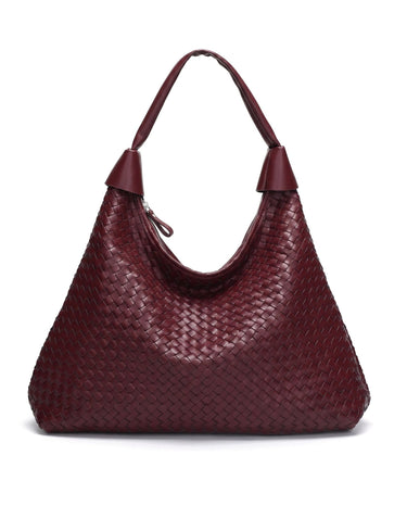 The Siren Woven Bag in burgundy, front view on a pure white studio background showing the woven body and knotted strap