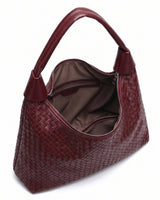 The Siren Woven Bag in burgundy, open top view showing the zip closure and taupe fabric lining