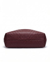 The Siren Woven Bag in burgundy, base view showing the woven underside