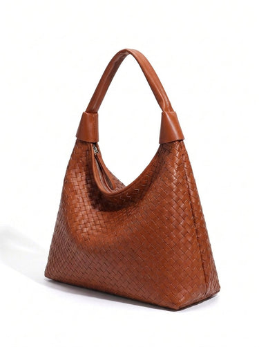 The Siren Woven Bag in caramel, three-quarter studio view showing the woven body and knotted strap