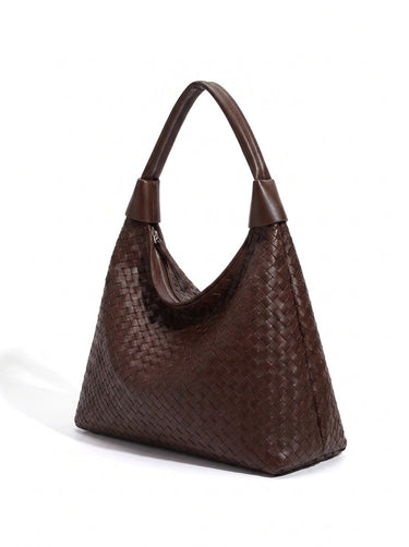 The Siren Woven Bag in brown, three-quarter studio view showing the woven body and knotted strap