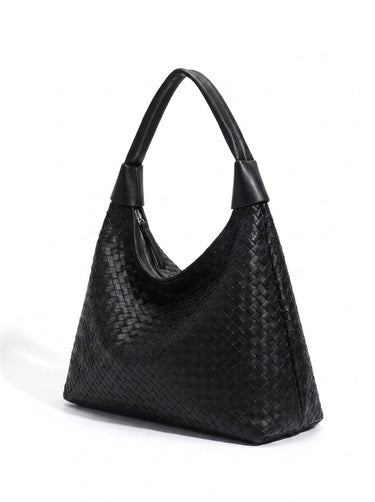 The Siren Woven Bag in black, three-quarter studio view showing the woven body and knotted strap
