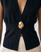 The Solara Gold Button Vest in black — close-up of the gold button and open front