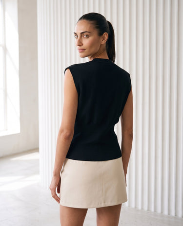 The Solara Gold Button Vest in black — sleeveless knit vest, back view on model