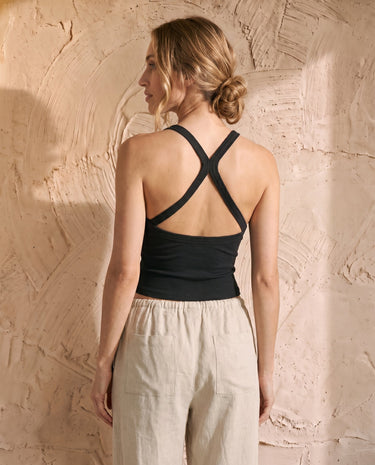 The Solene Camisole in black — ribbed cross-back camisole, back view on model