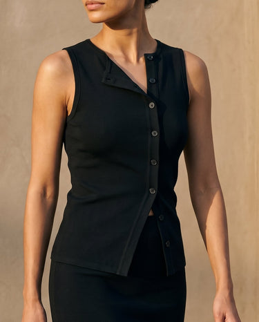 Close front view of the black top's asymmetric button placket and folded lapel – Moriel Heritage