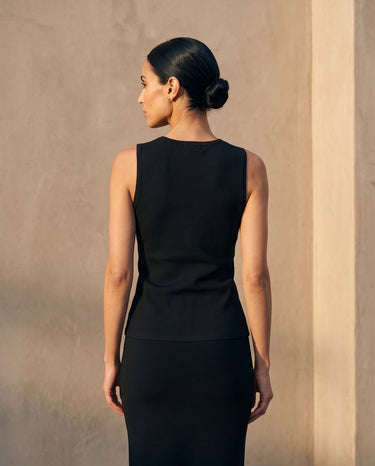Back view of the black sleeveless top showing the fitted shape – Moriel Heritage
