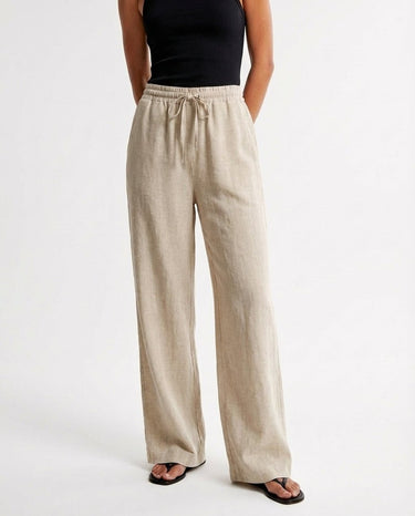 The Verena Cotton Linen Trousers in beige — wide-leg drawstring trousers, front view on model