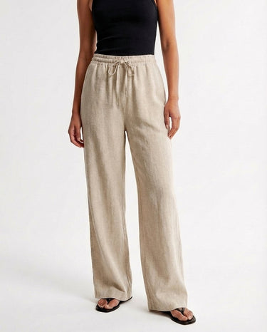 The Verena Cotton Linen Trousers in beige — wide-leg drawstring trousers, front view on model