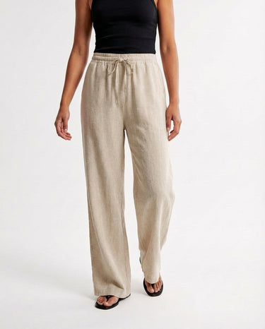 The Verena Cotton Linen Trousers in beige — wide-leg trousers, front styling view on model