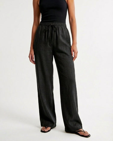 The Verena Cotton Linen Trousers in black — wide-leg drawstring trousers, front view on model