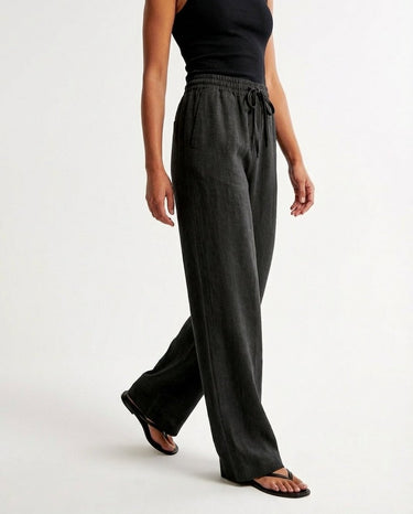 The Verena Cotton Linen Trousers in black — wide-leg trousers, side view on model