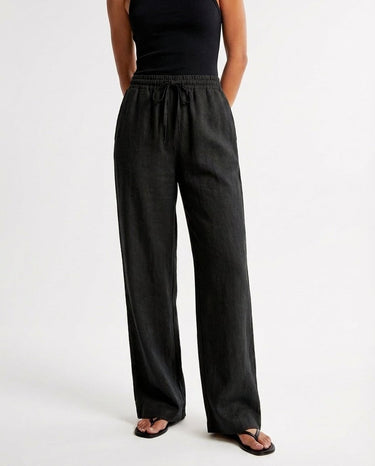 The Verena Cotton Linen Trousers in black — wide-leg drawstring trousers, front view on model