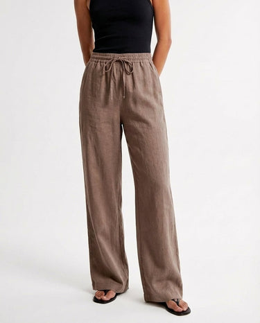 The Verena Cotton Linen Trousers in coffee — wide-leg drawstring trousers, front styling view on model