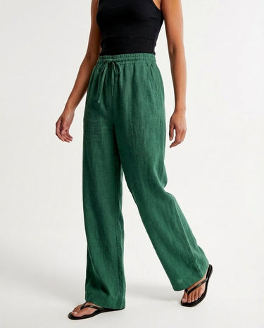 The Verena Cotton Linen Trousers in green — wide-leg trousers, side view on model