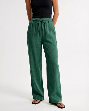 The Verena Cotton Linen Trousers in green — wide-leg drawstring trousers, front view on model