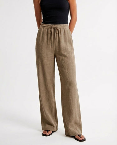 The Verena Cotton Linen Trousers in khaki — wide-leg drawstring trousers, front view on model