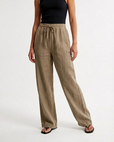 The Verena Cotton Linen Trousers in khaki — wide-leg trousers, side styling view on model