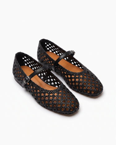 The Wren Mary Janes in black — woven square-toe flats with buckle strap, angled pair view