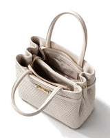 The Camille Handbag in ivory, open top view showing the compartmented interior and zip divider