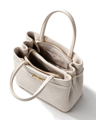 The Camille Handbag in ivory, open top view showing the compartmented interior and zip divider
