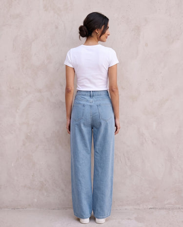 The Tiela Adjustable Jeans in blue — wide-leg jeans, back view on model