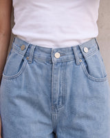 The Tiela Adjustable Jeans in blue — close-up of the waistband and adjustable buttons