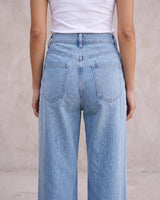 The Tiela Adjustable Jeans in blue — close-up of the back waistband and rear pockets