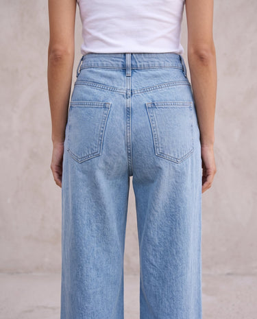 The Tiela Adjustable Jeans in blue — close-up of the back waistband and rear pockets