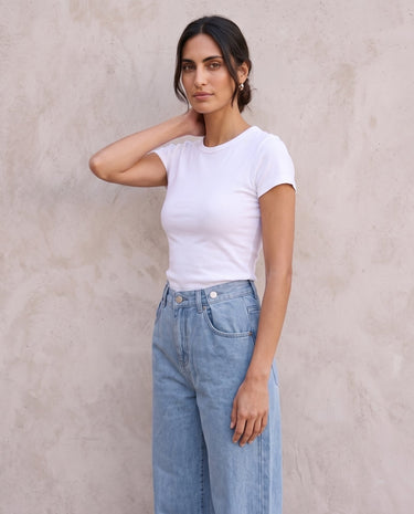 The Tiela Adjustable Jeans in blue — wide-leg jeans, side view on model