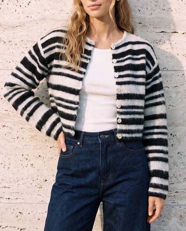 Tilia Knit Cardigan in white and black — worn open over a white tank with dark jeans, front view on model