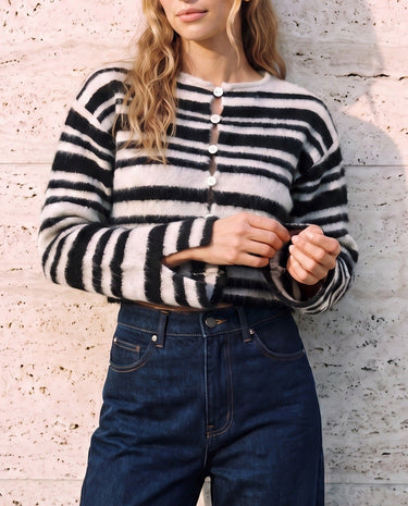 Tilia Knit Cardigan in white and black — front view on model adjusting the split cuff
