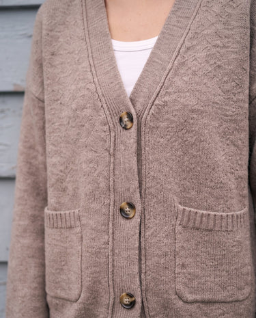 The Vintage Rosabele Cardigan in brown — close-up of the V-neck and front pockets