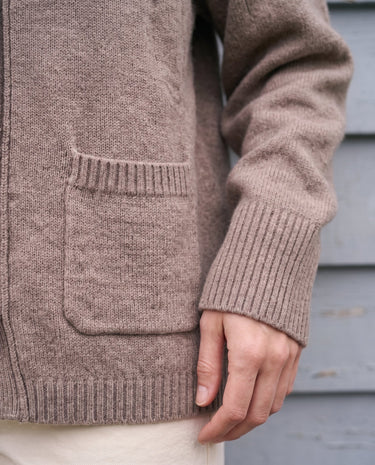 The Vintage Rosabele Cardigan in brown — close-up of the oversized front pocket and ribbed cuff