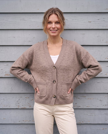 The Vintage Rosabele Cardigan in brown — knit cardigan, front view with hands on hips on model