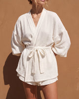 White Seaside Amalfi Set in white — crinkle-texture wrap top with tie waist and shorts, front view on model