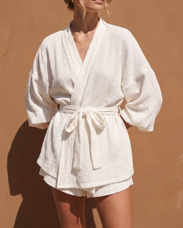 White Seaside Amalfi Set in white — crinkle-texture wrap top with tie waist and shorts, front view on model