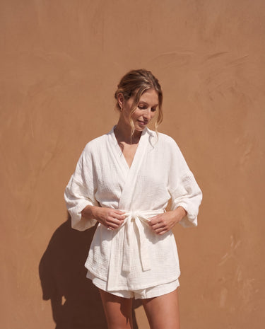 White Seaside Amalfi Set in white — full front view on model against a sunlit terracotta wall