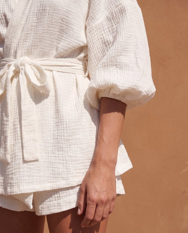 White Seaside Amalfi Set in white — detail of the crinkle-texture fabric, tie belt and gathered cuff