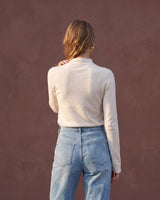 Model wearing pearl white mock-neck knit top, back view – Moriel Heritage
