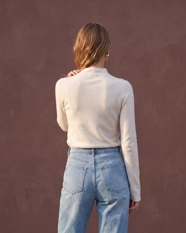 Model wearing pearl white mock-neck knit top, back view – Moriel Heritage
