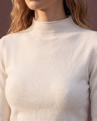 Close-up of pearl white top showing the mock neckline and knit texture – Moriel Heritage