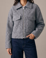 Zoe Coat in gray — cropped tweed-effect jacket zipped up, front view on model with hand in pocket